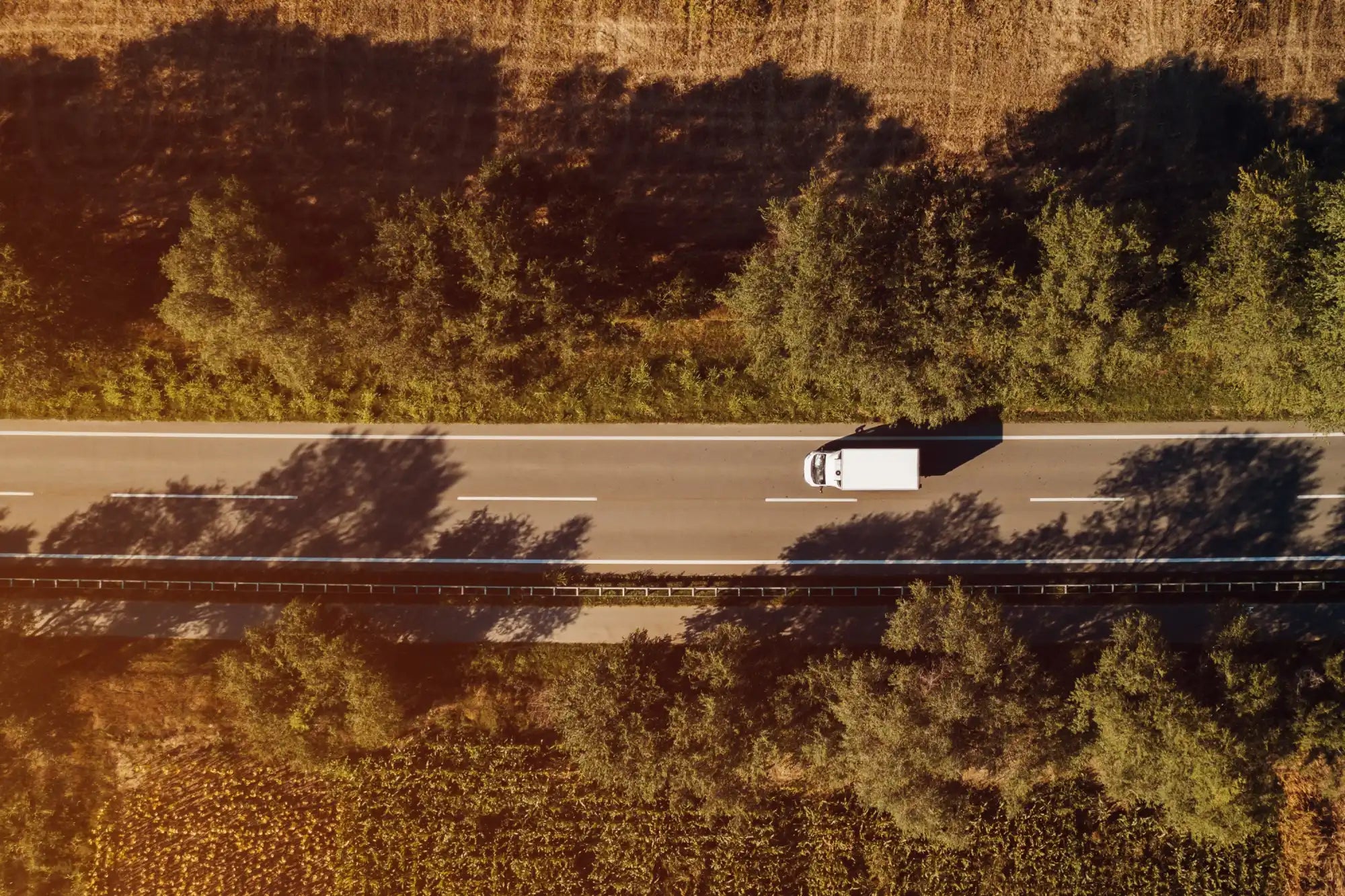 White delivery truck on a highway.
